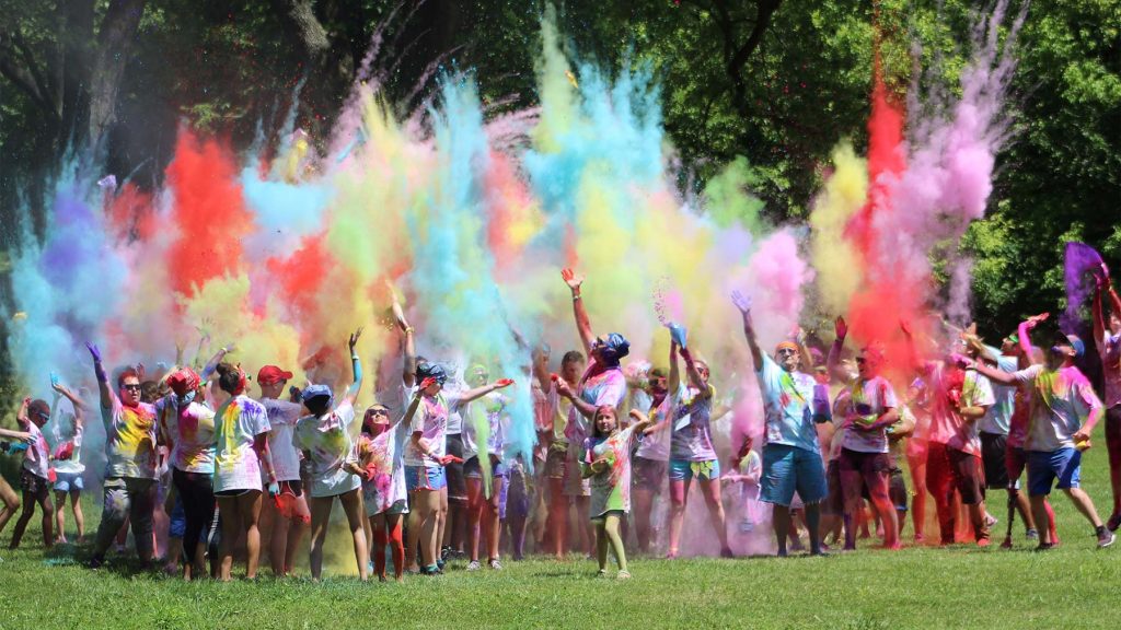 campers throwing color dust in the air