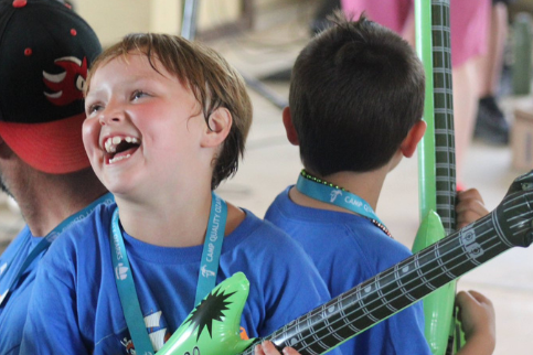 Camp Quality Camper playing guitar enjoying camp