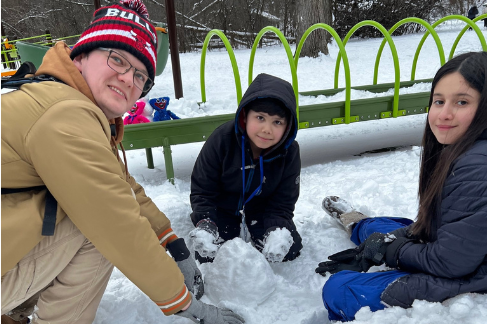 campers during winter weekend making snowballs